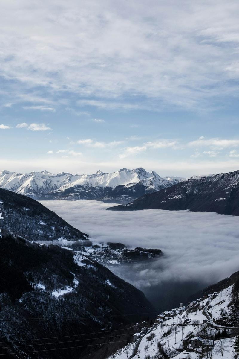 An image depicting a rural community with a backdrop of snowy mountains, emphasizing Tumbler Ridge's remote setting during winter.