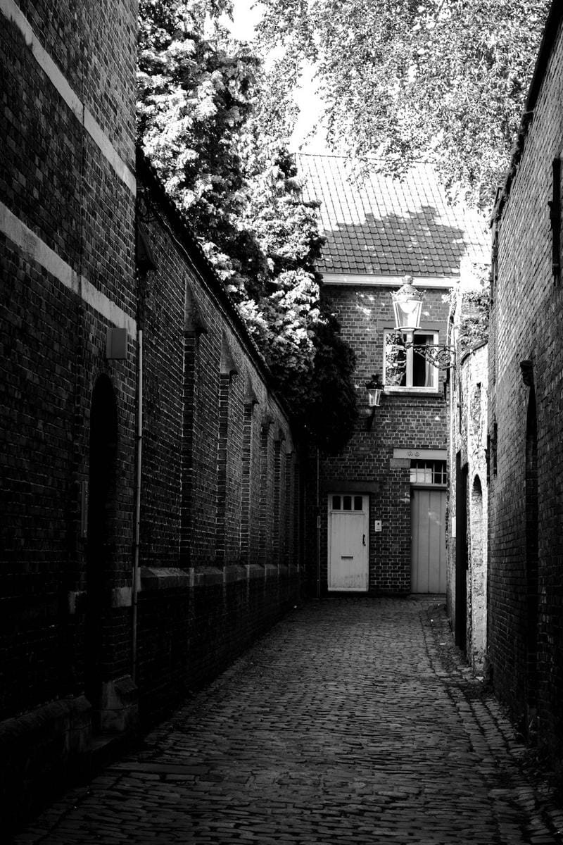 A humorous cartoon of someone tripping over their own shoelaces in a busy city street