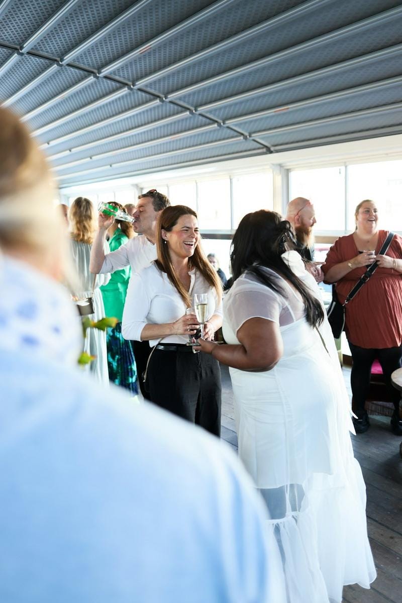 A person laughing with friends at a casual get-together, highlighting shared humor