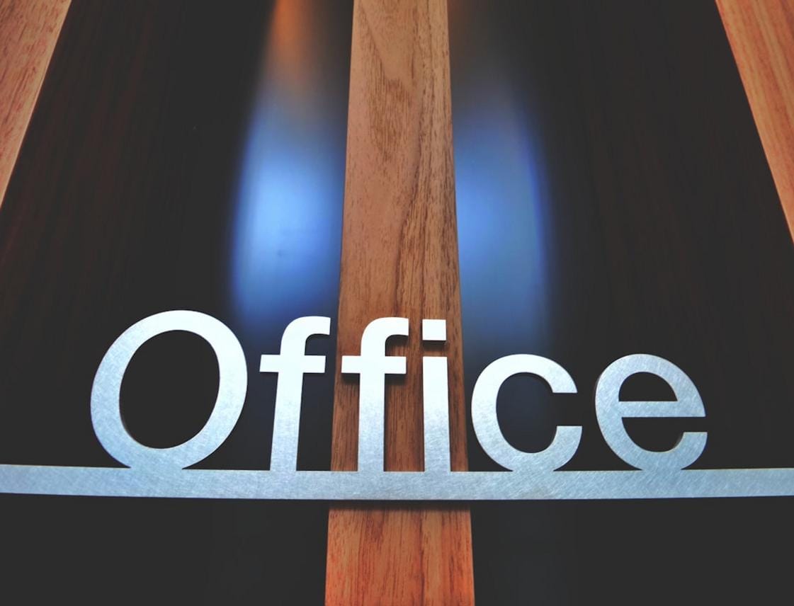 A humorous illustration of someone raising their hand with a confused expression in a crowded office