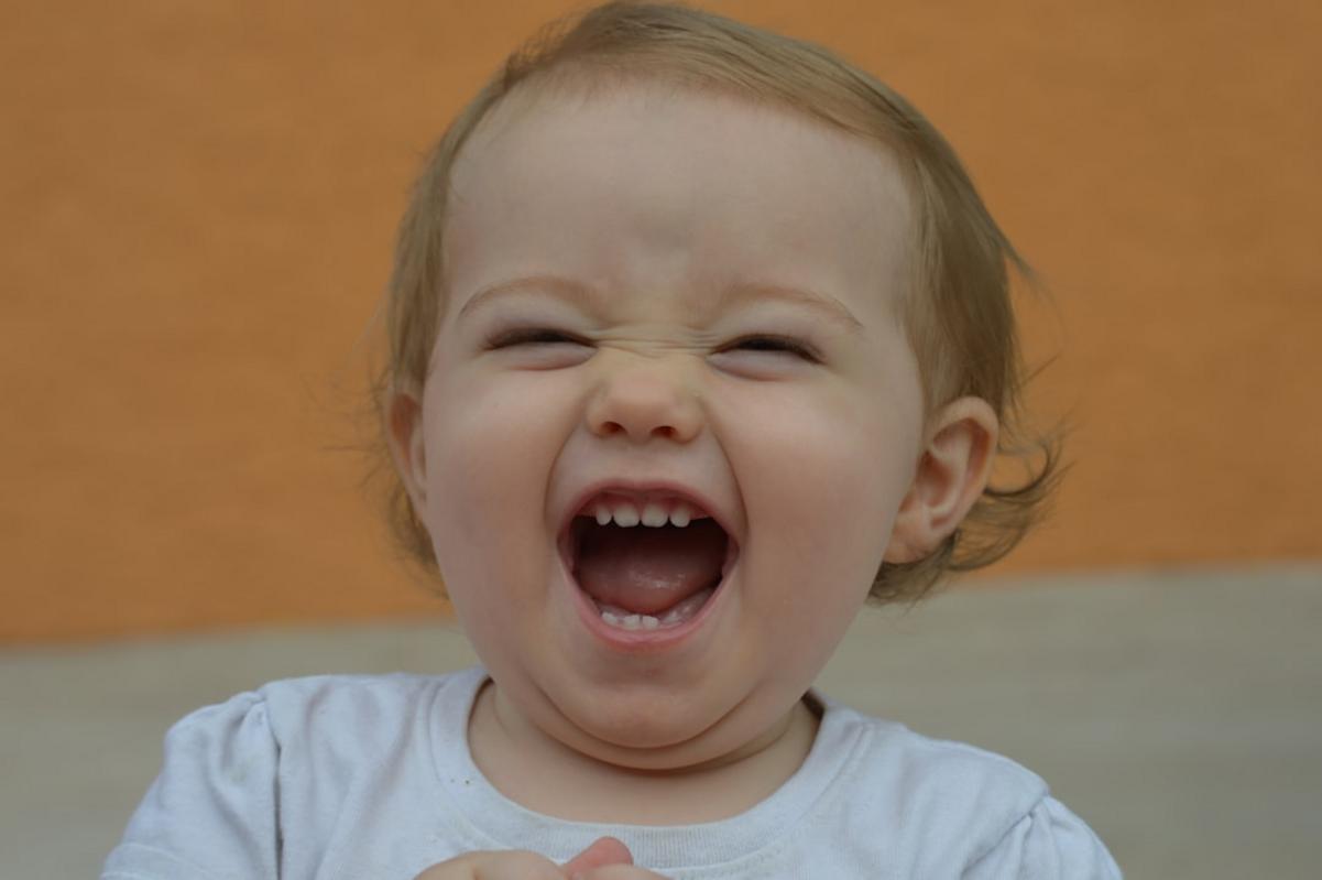 An image of a person laughing at a funny mistake involving a spilled drink or an unexpected wardrobe malfunction