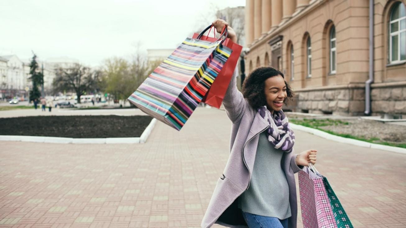 a comic scene of someone humorously struggling with oversized shopping bags