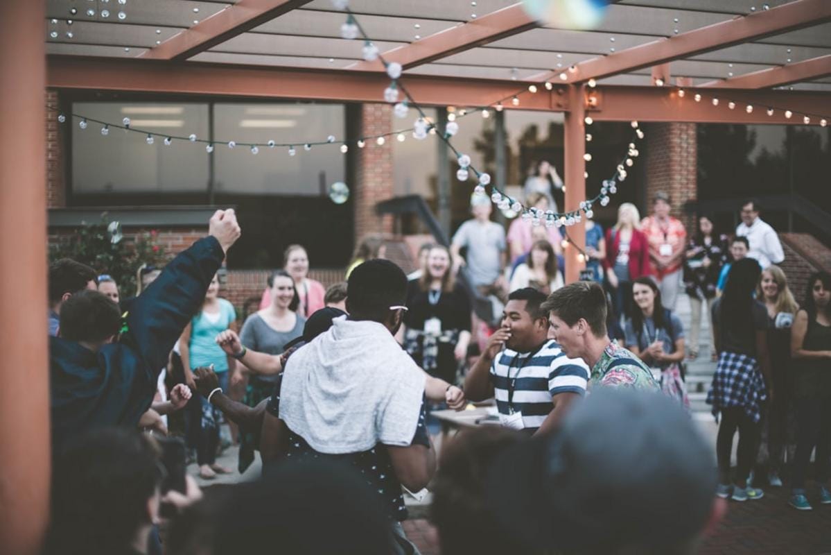 A cheerful group of friends laughing at a funny story during a casual gathering