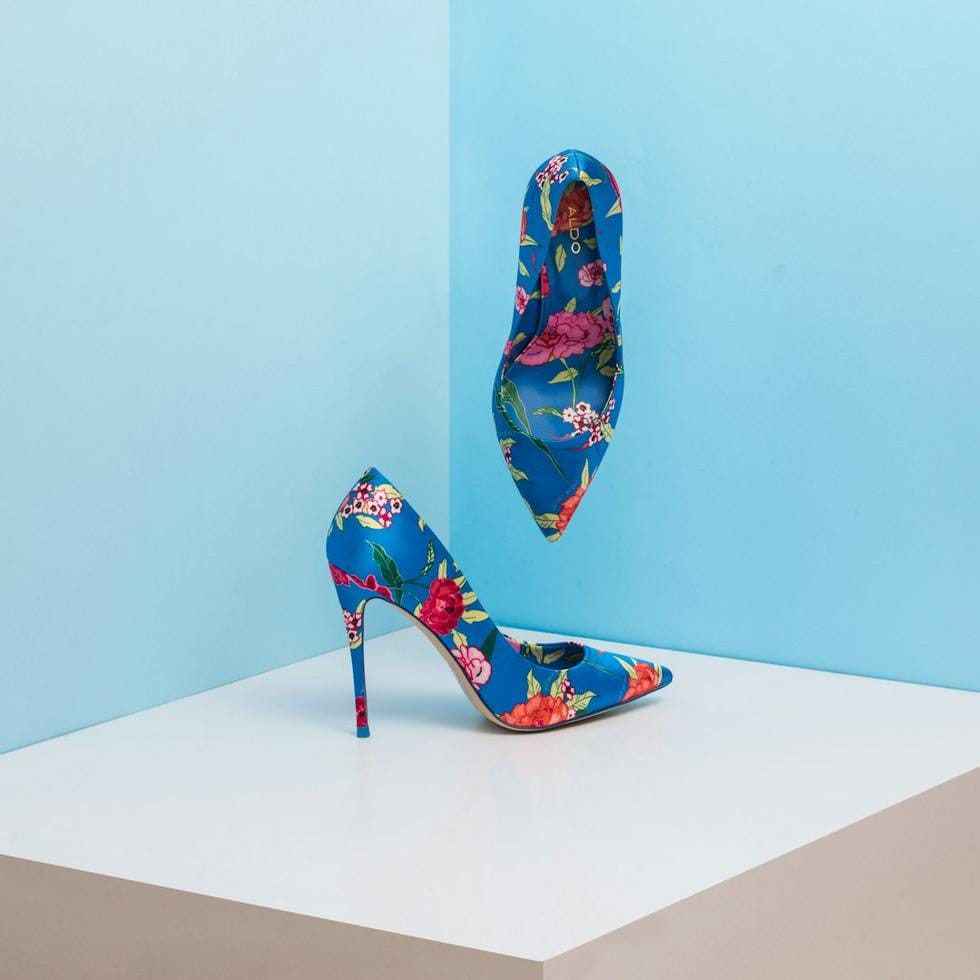 A humorous scene of a person accidentally wearing mismatched shoes on a busy city street