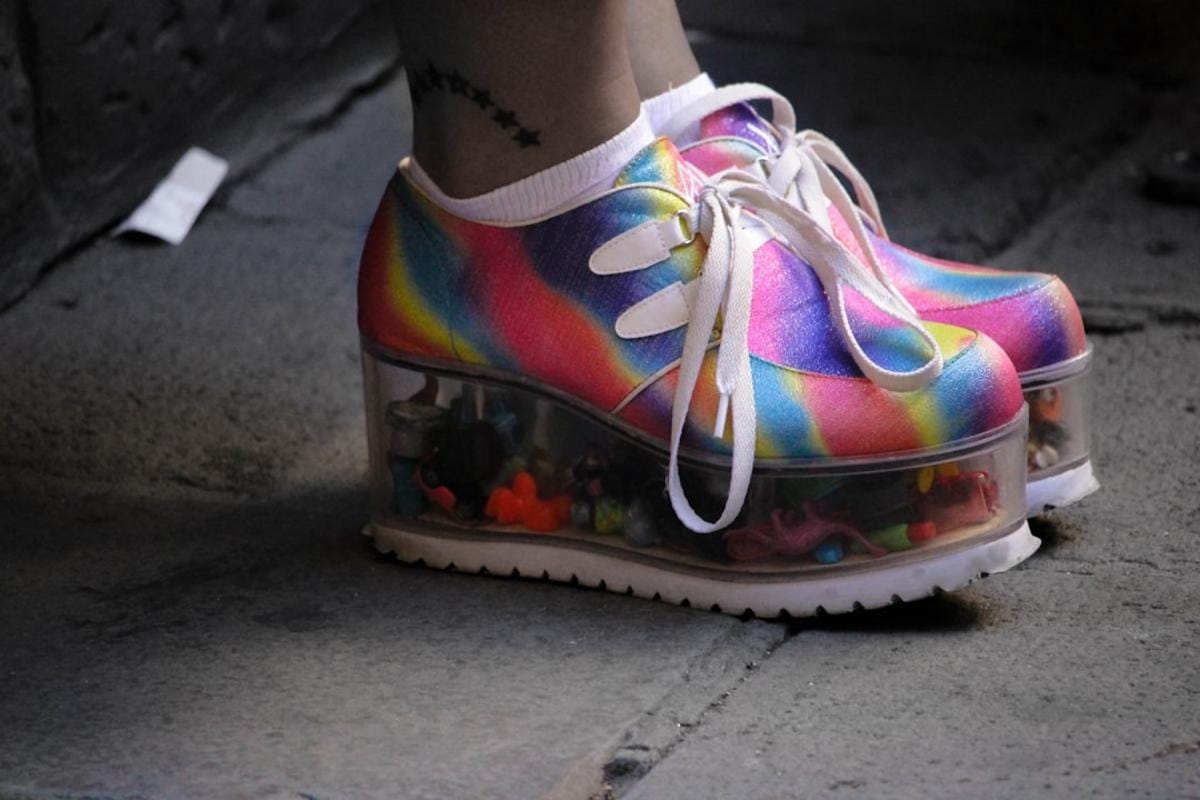a humorous photo of a person with a mismatched shoe and a big smile