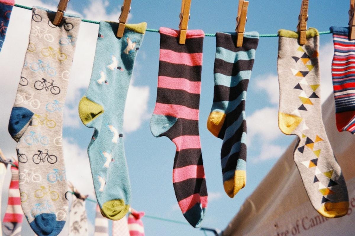 A humorous depiction of a person accidentally wearing two different socks and happily going about their day, attracting amusing glances from others.