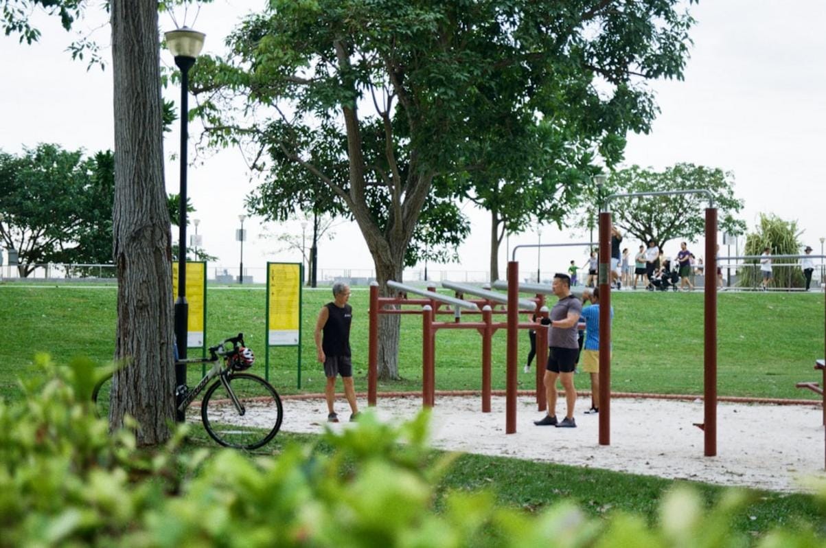 a diverse group of adults engaging in group fitness activities outdoors, symbolizing community health efforts